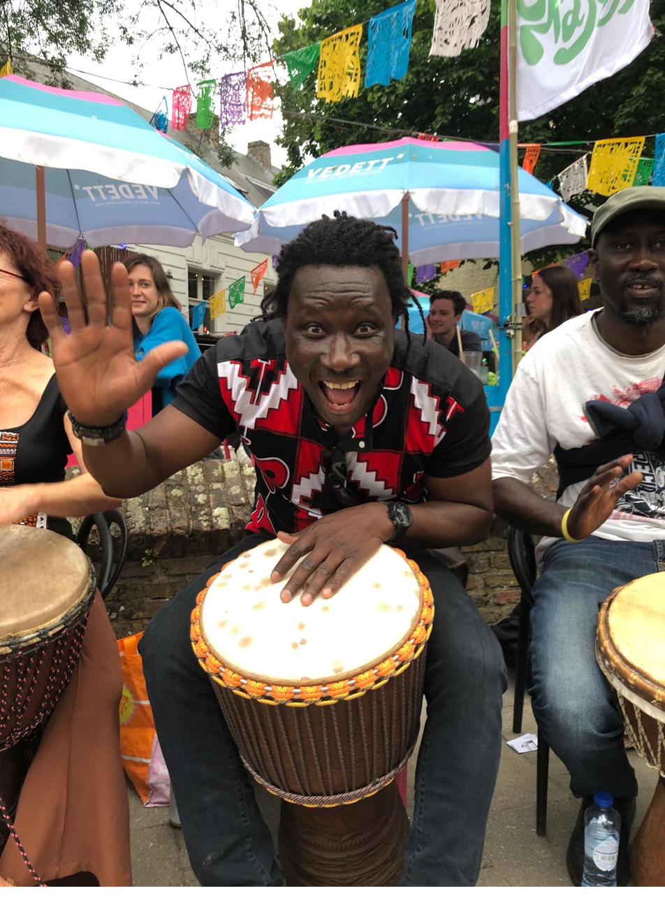 Moussa Dembélé playing djembe in a drum circle